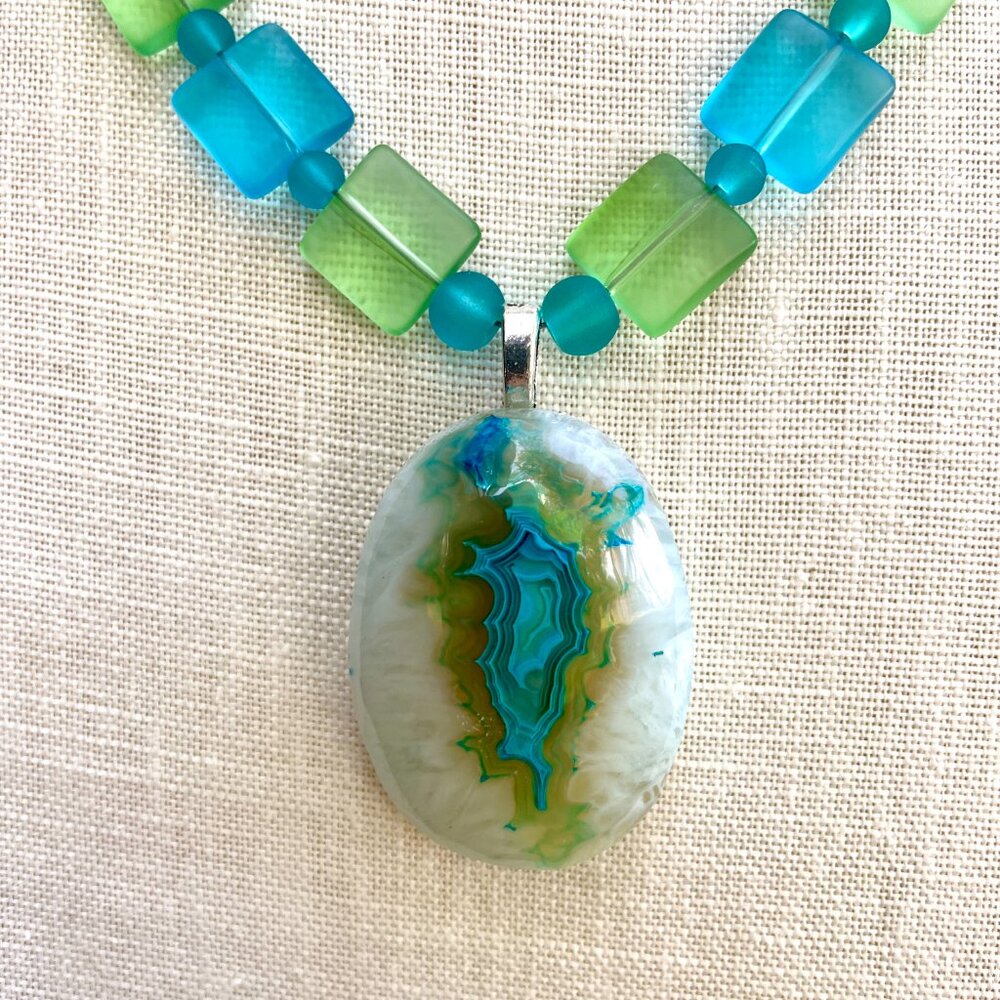 A stunning blue Onyx Agate Druzy pendant strung with square sea glass beads